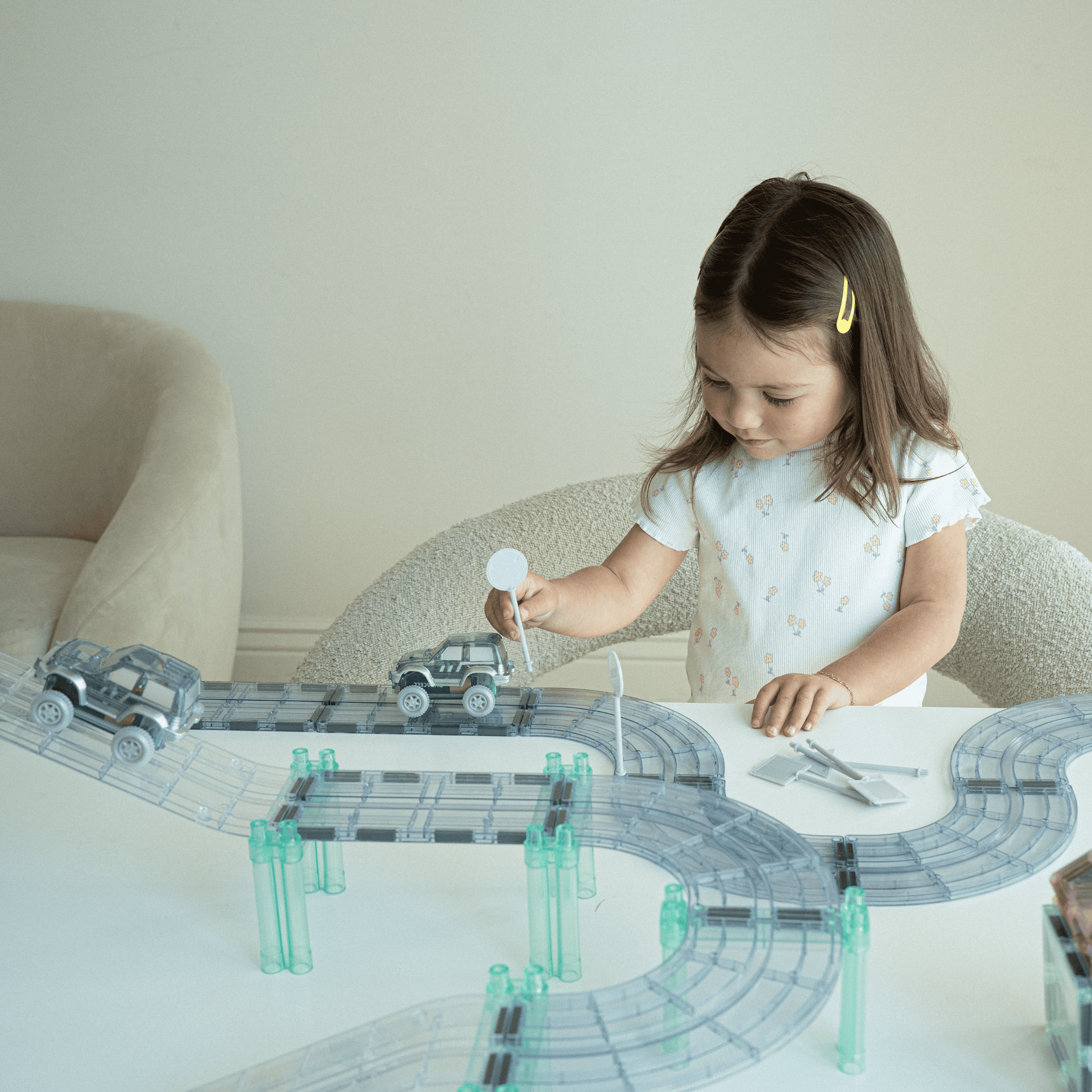 Magnetic race track for kids with battery powered cars