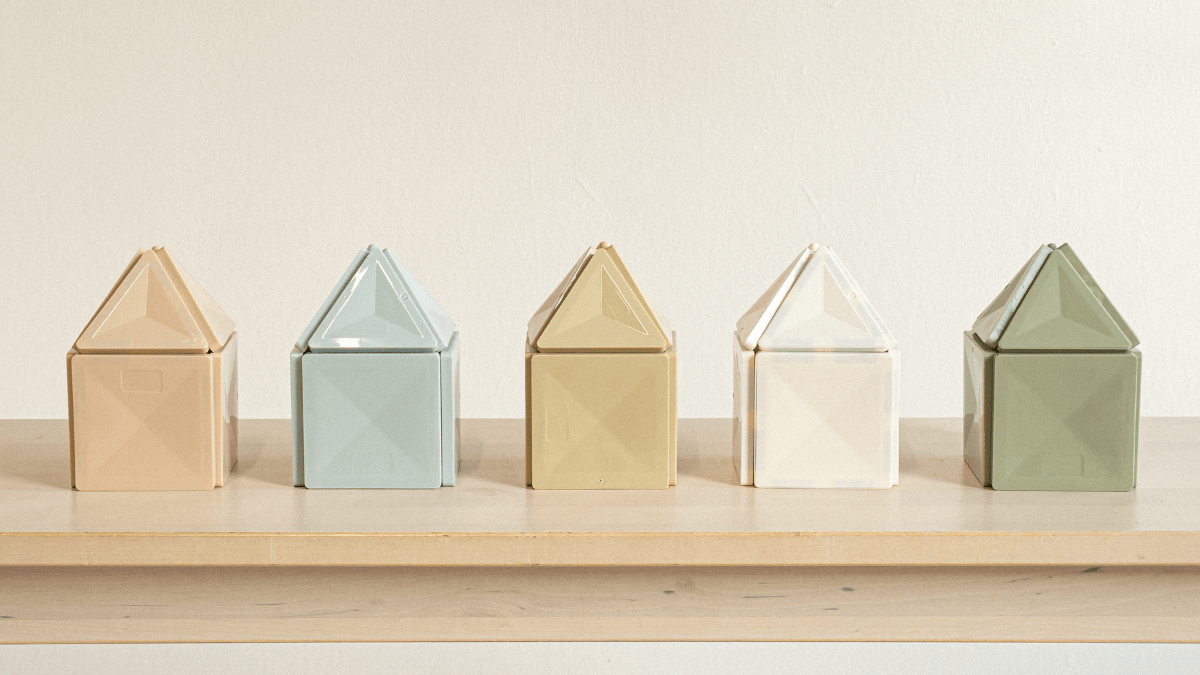 Pastel magnetic tiles built into castle structure on hardwood floor in modern playroom