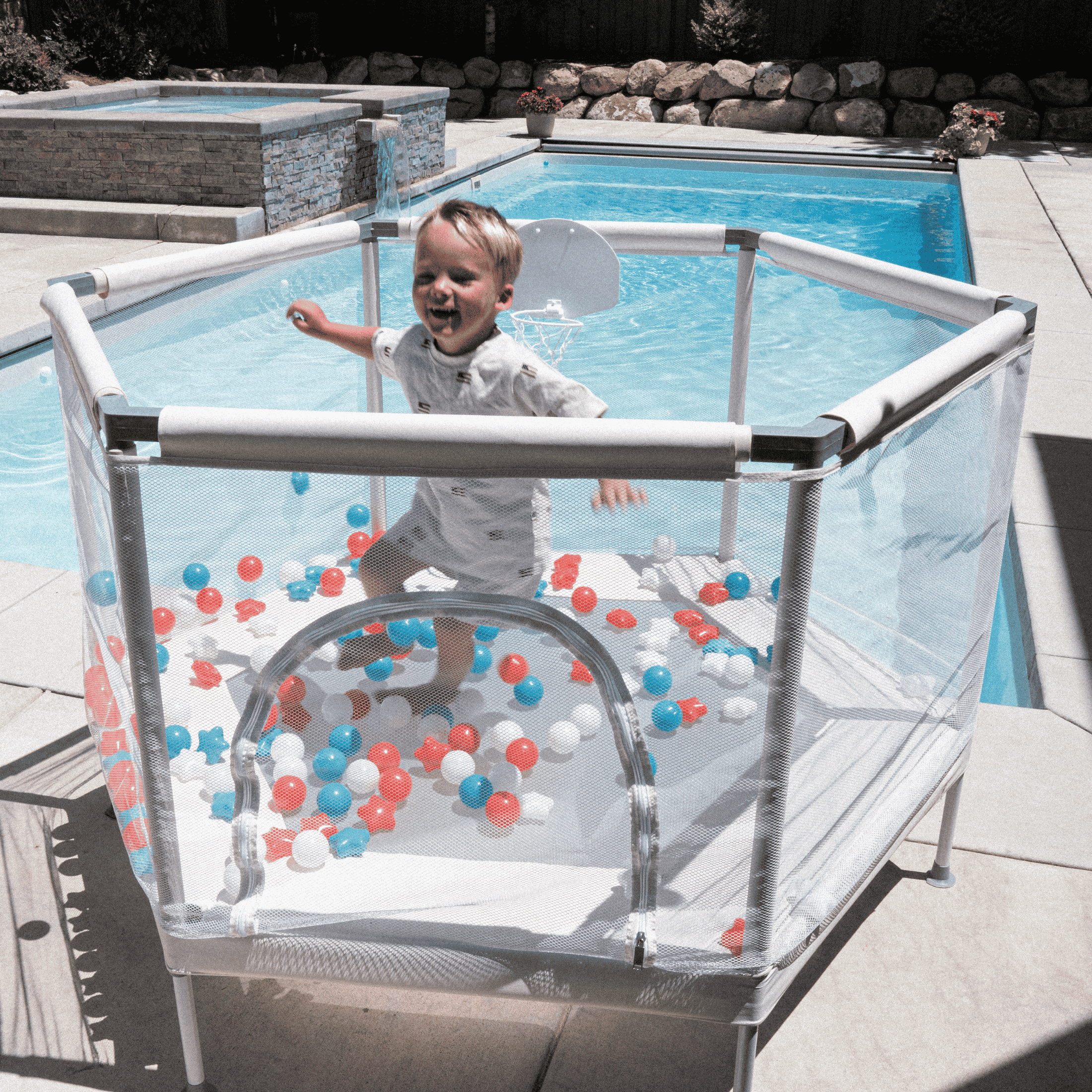 Toddler jumping on blue indoor trampoline